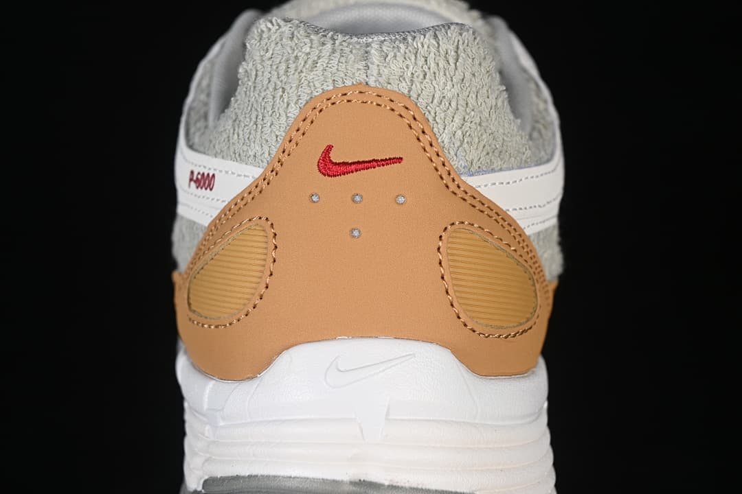 Close-up of the tan heel overlay and red logo detail
