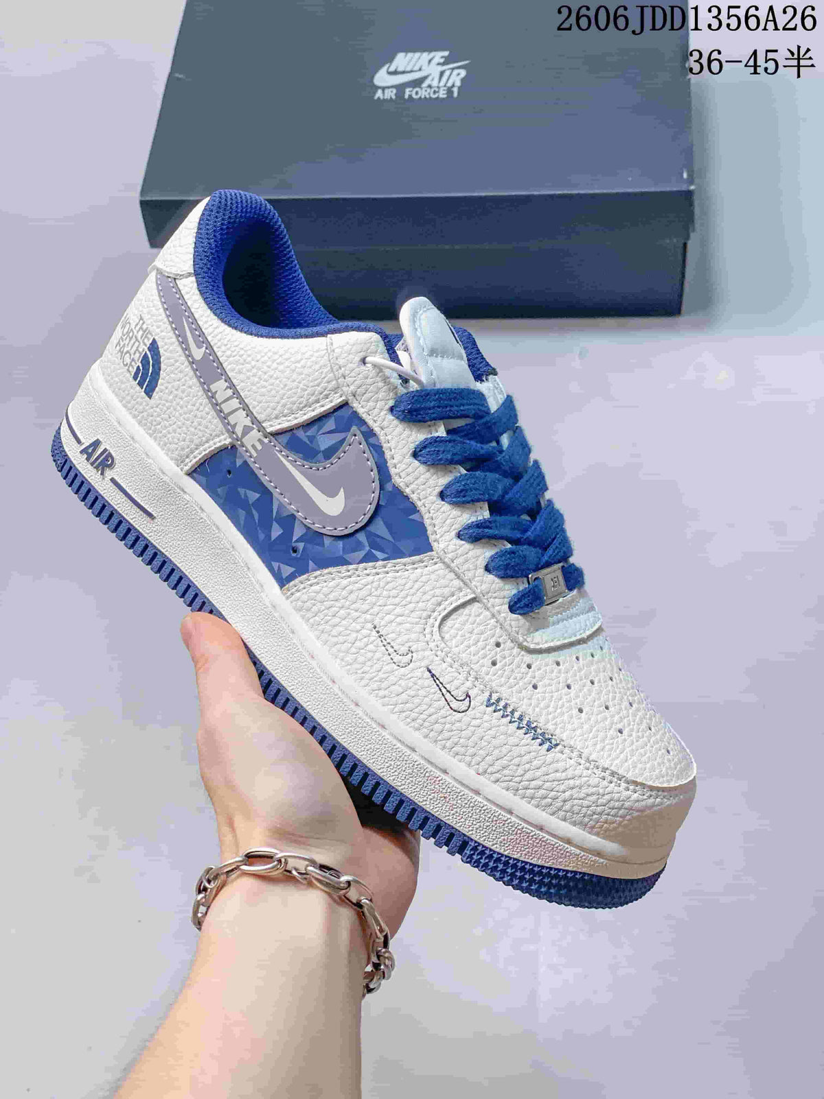 White Nike Air Force 1 low-top sneaker with blue patterned panels and blue laces
