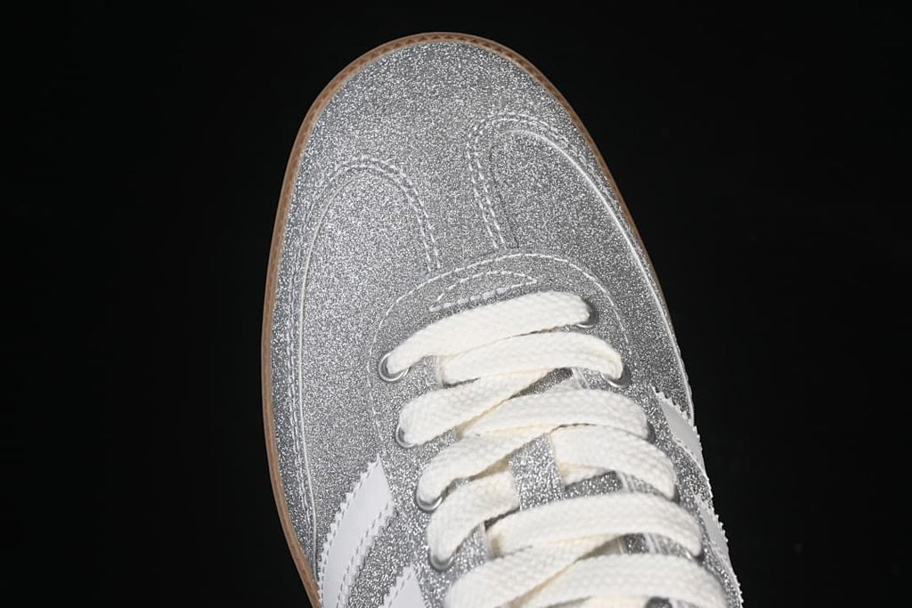 Top-down close-up of the silver glitter-effect toe and cream laces.