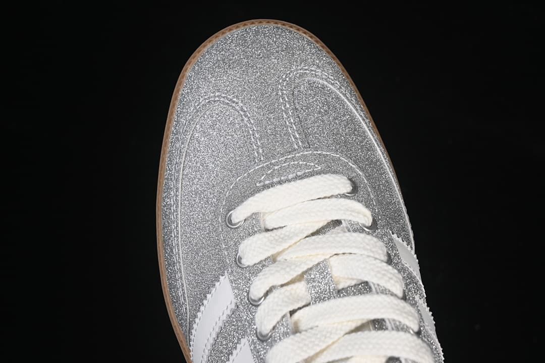 Top-down close-up of the silver glitter-effect toe and cream laces.