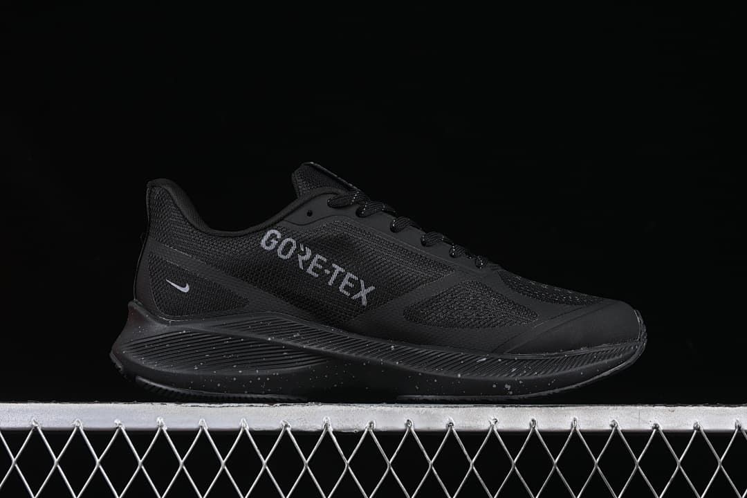 Side view showing GORE-TEX lettering and the black speckled midsole.