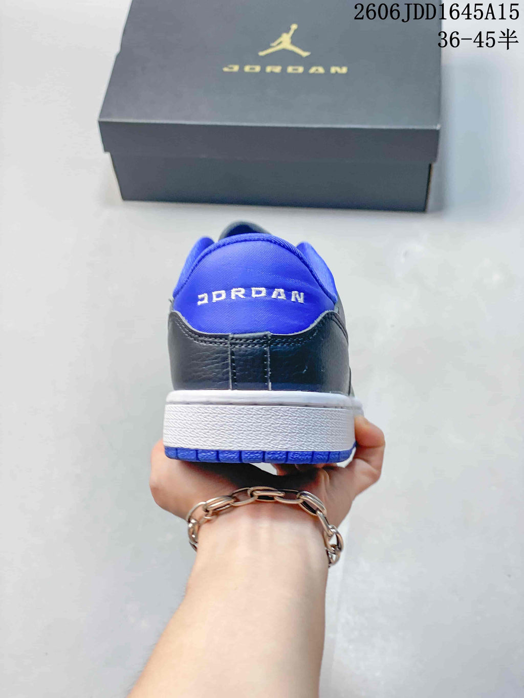 Rear view showing the blue heel panel and white midsole
