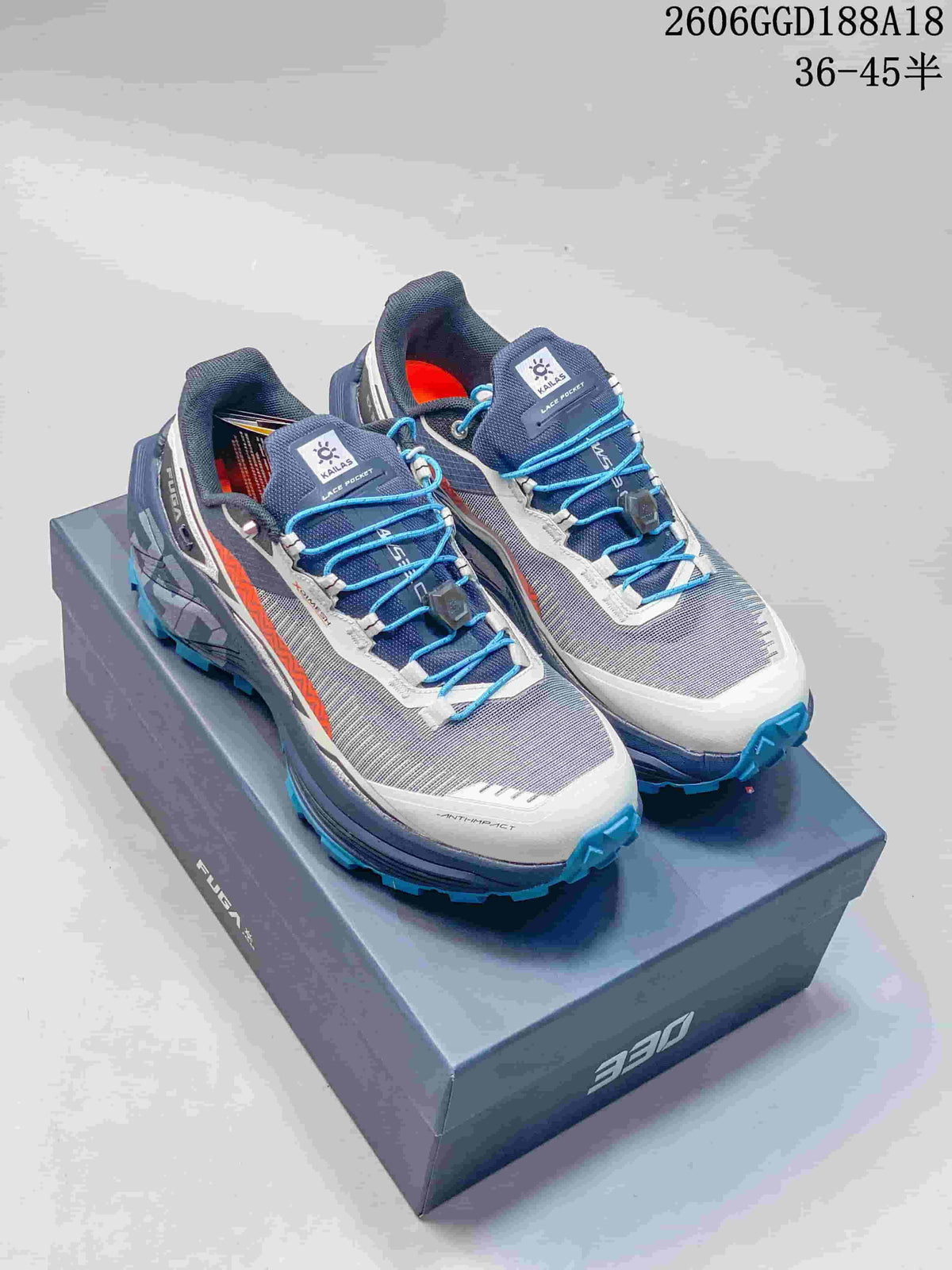 Pair of gray and navy Kailas Fuga EX330 trail shoes with blue quick laces and rugged blue outsoles