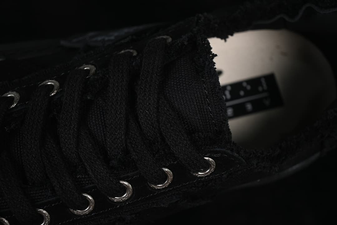 Close-up of black laces and metal eyelets