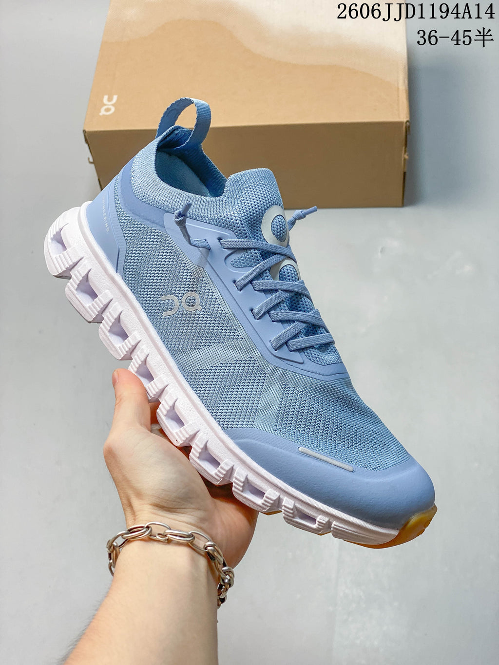 Angled side view of a blue sneaker with a white segmented outsole.