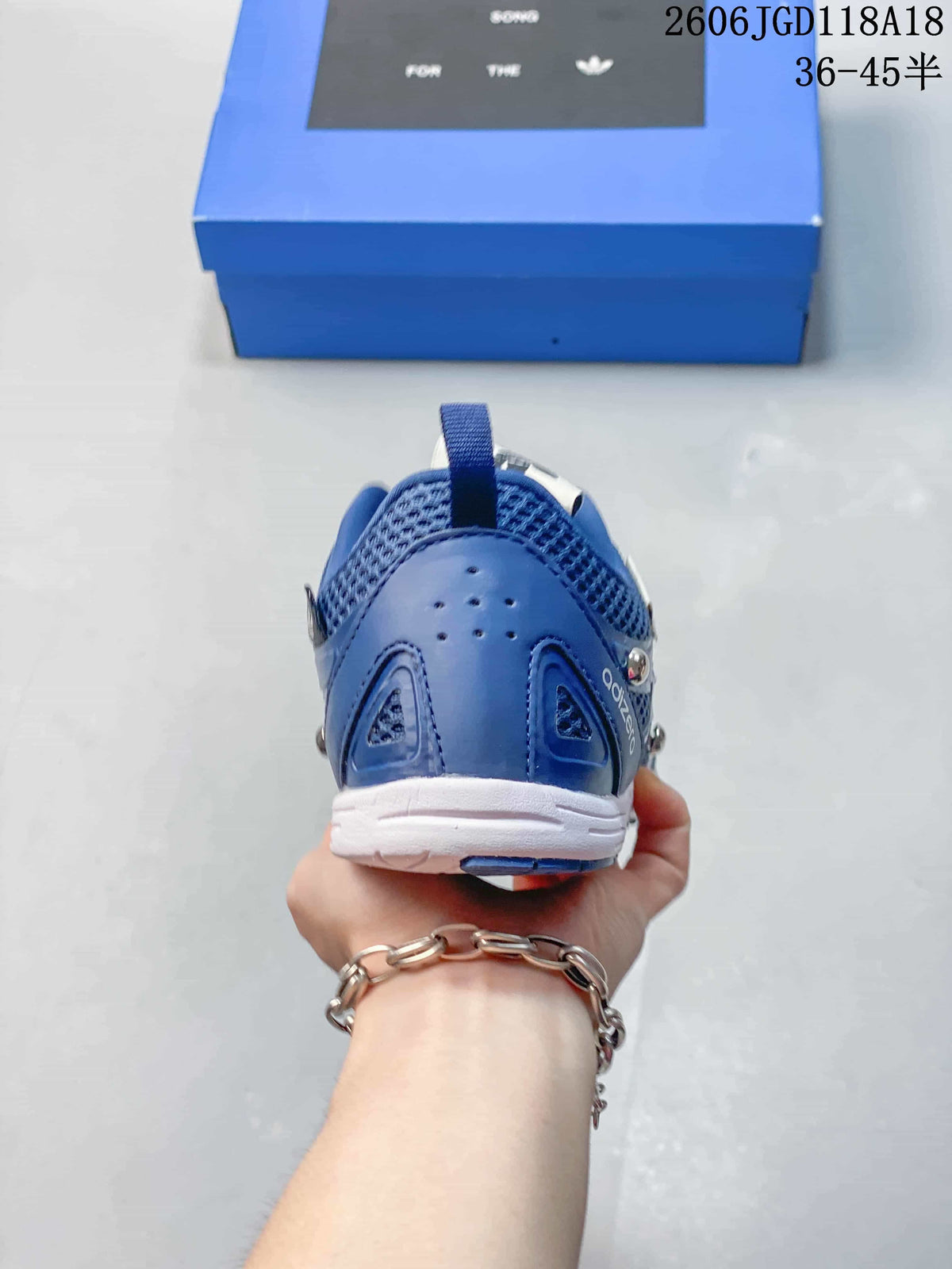 Rear view showing the blue heel and white outsole.