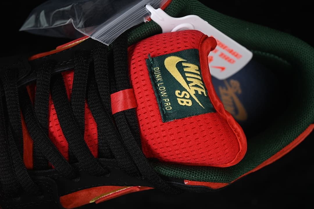 Close-up of the red perforated tongue, Nike SB label, and black laces.