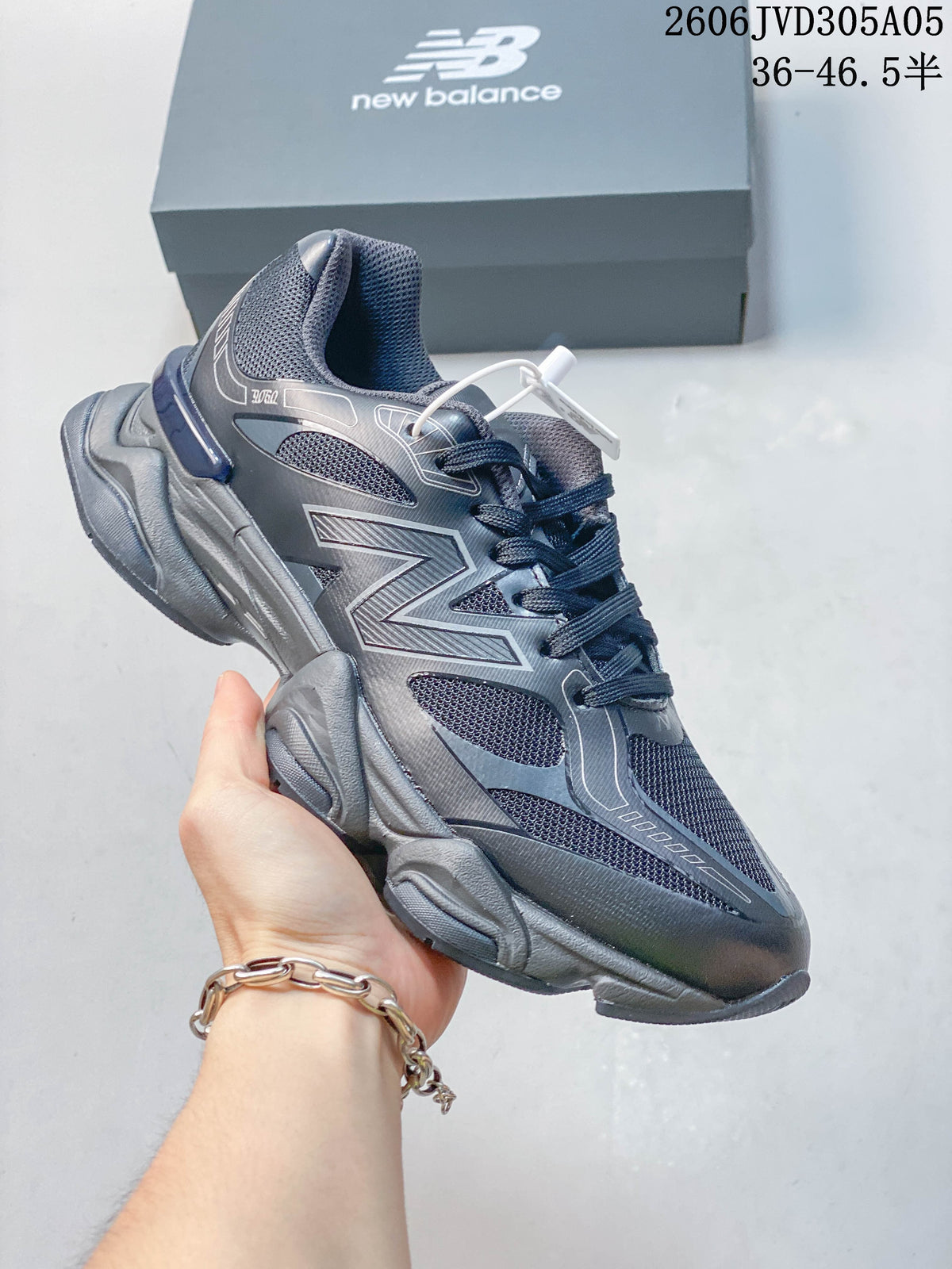 Side view of the dark gray and navy sneaker with mesh panels.