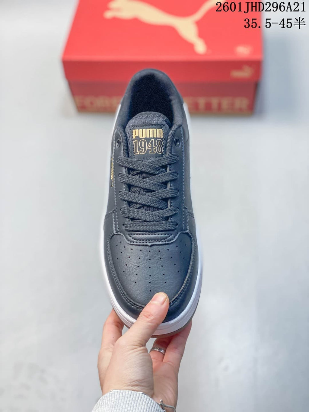 Top view of a navy PUMA Caven 2.0 Retro sneaker with perforated toe and lace-up fastening