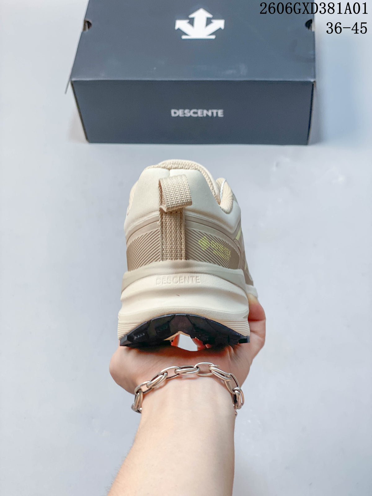 Rear view of the beige DESCENTE sneaker showing the heel and pull tab