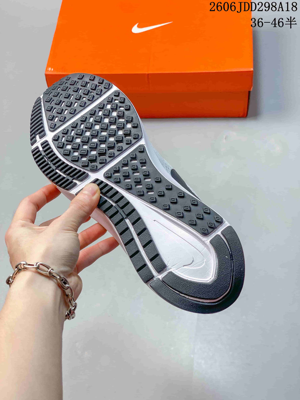 Underside of the Nike shoe showing patterned rubber tread and the midsole.