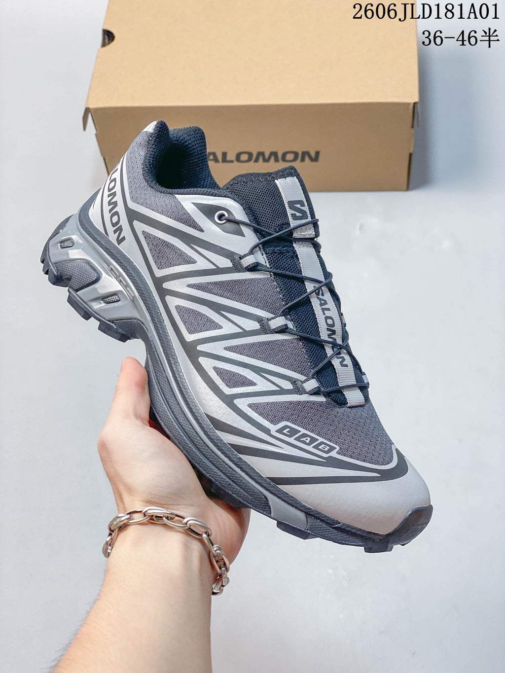 Angled side view of a gray, black, and silver Salomon XT-6 sneaker