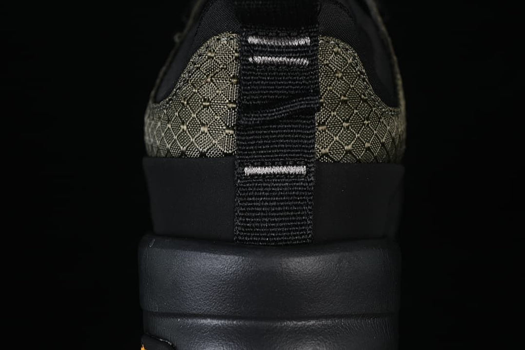 Rear view showing the patterned heel, pull tab, and black sole