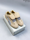 Pair of beige Puma Speedcat sneakers with silver side stripes, gray laces, and removable lace flaps.