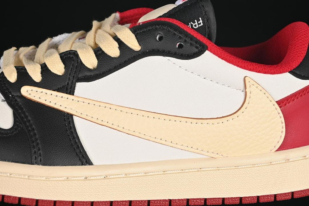 Close-up of the cream oversized Swoosh, white side panel, and red collar lining