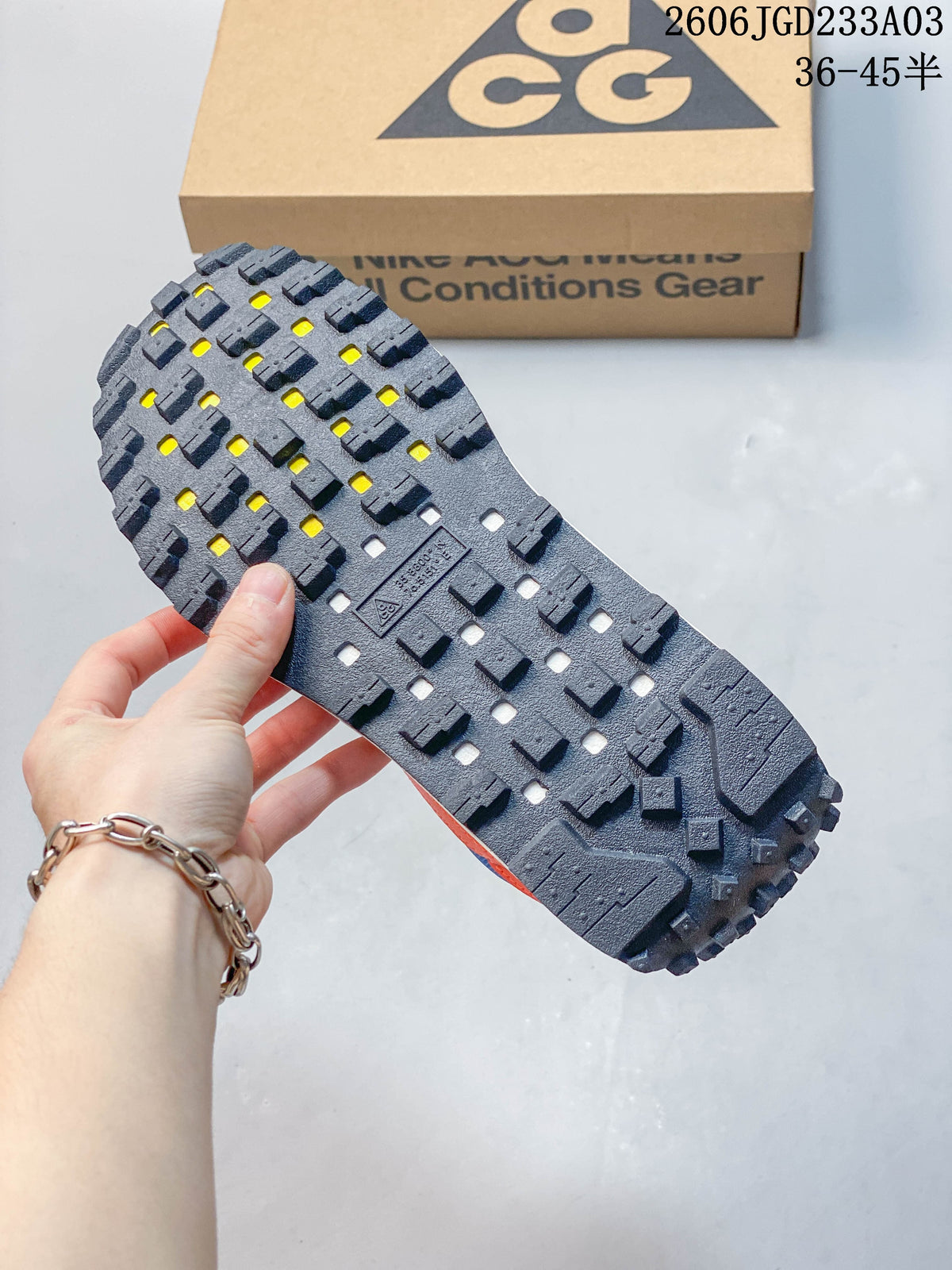 Close-up of the dark lugged outsole with yellow accents
