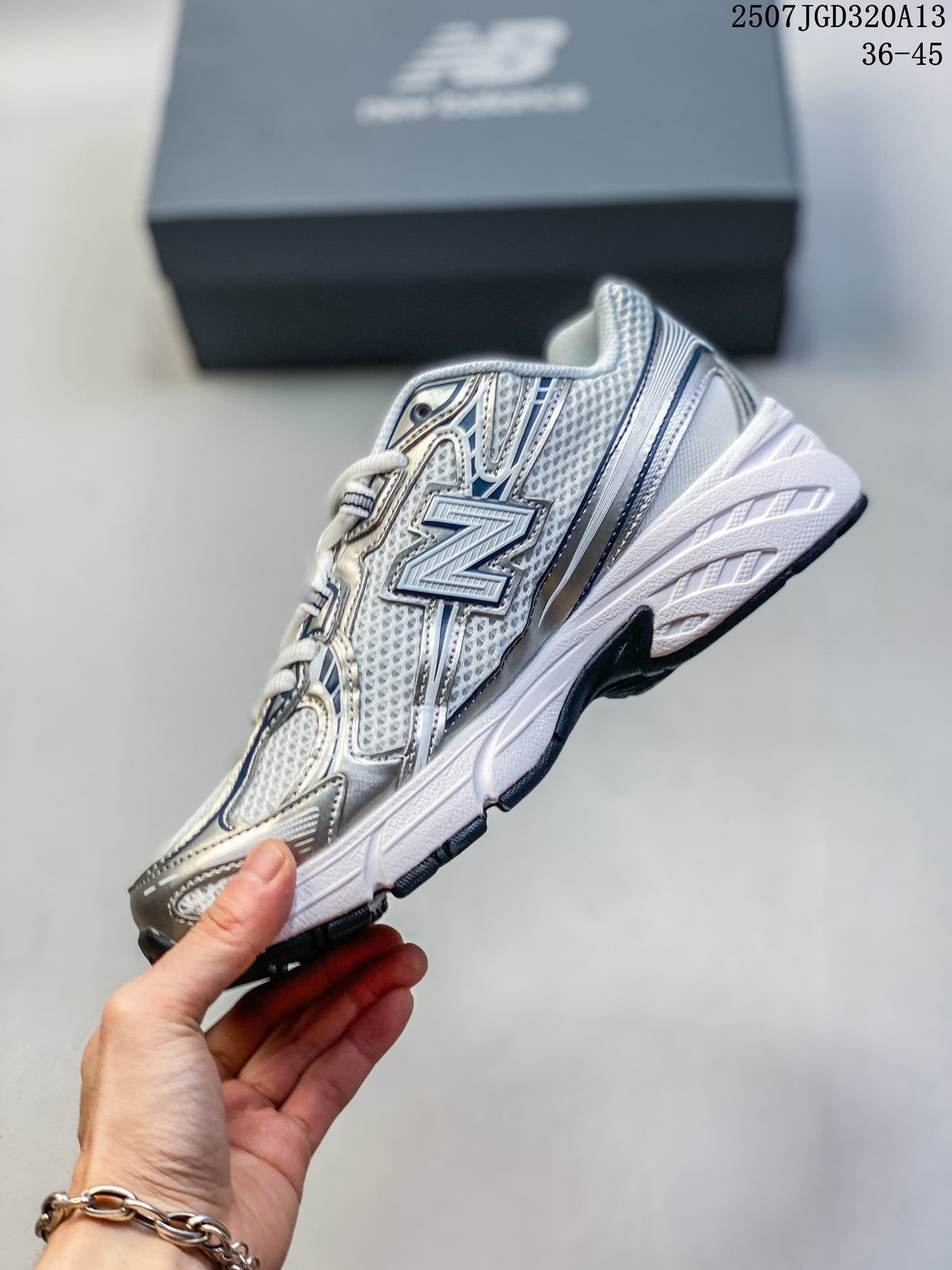 Side profile of the silver and white New Balance sneaker with a navy-accented N logo.