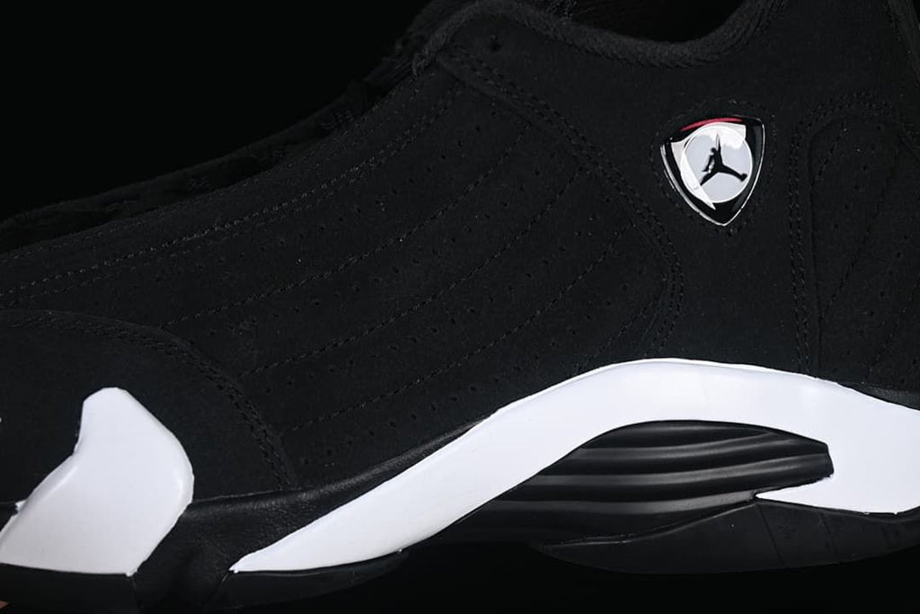 Close-up of the black upper, side emblem, and white midsole