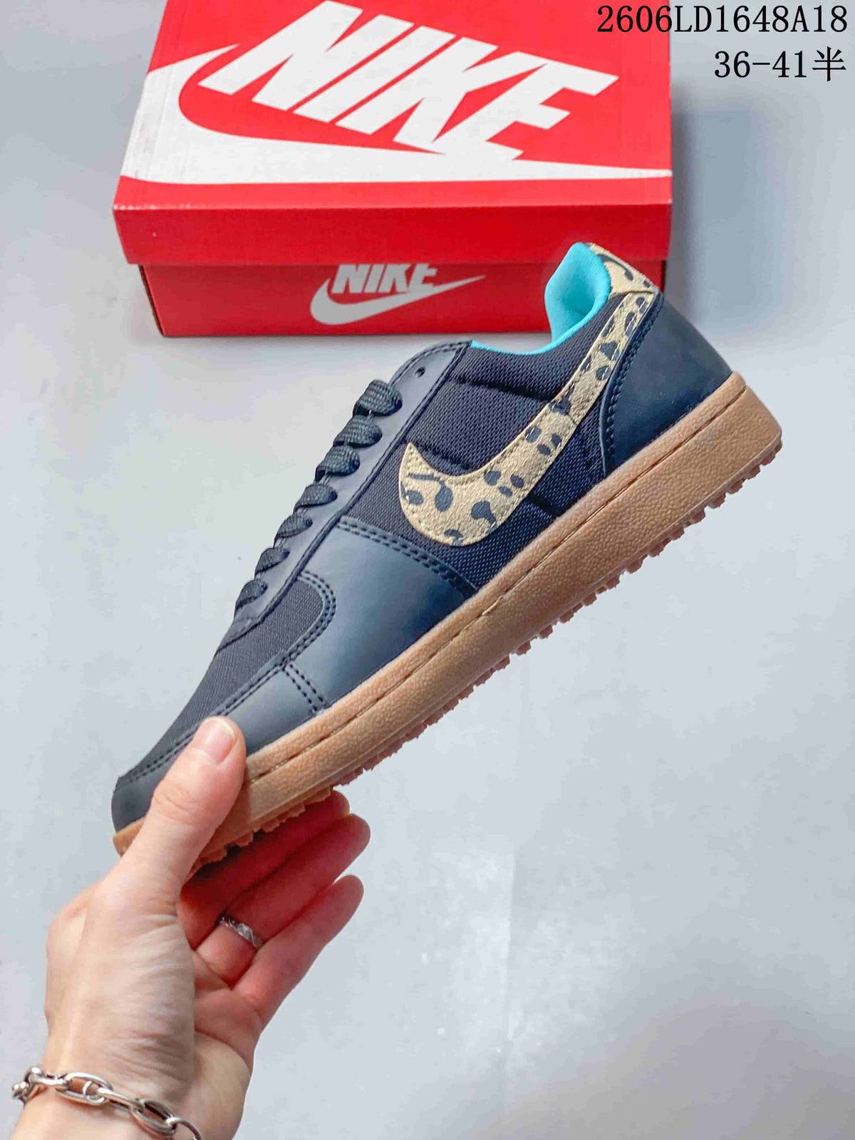 Side view of the low-top sneaker with a leopard-print Swoosh and gum-colored sole