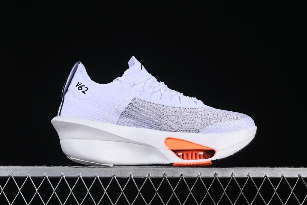 Side profile of a white running shoe with orange midsole accents