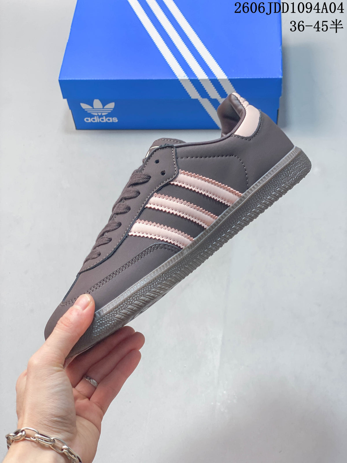 Side profile of the Adidas Samba OG sneaker with pale pink stripes and a gray-brown outsole