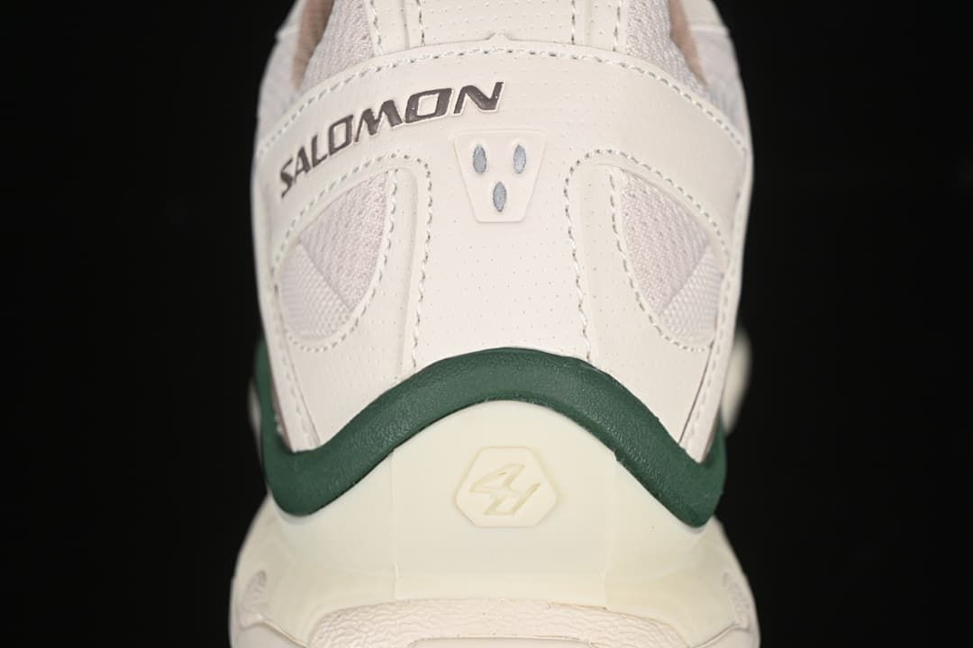 Rear view of the shoe with Salomon branding and a dark green heel accent.