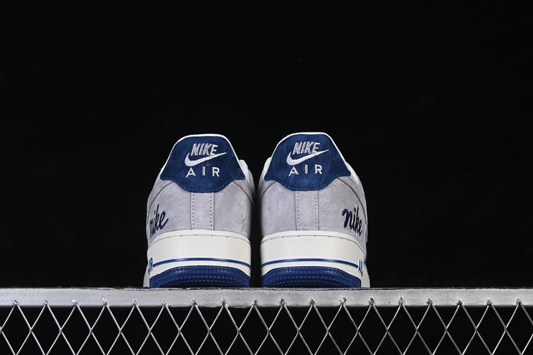 Rear view of both shoes with navy heel tabs and gray heel panels.