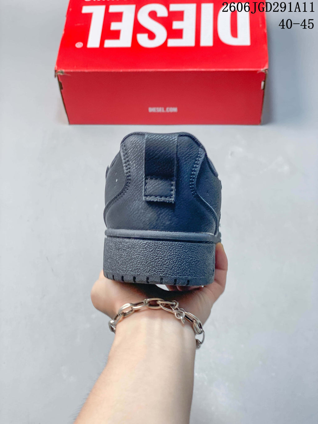 Rear view of a dark gray low-top sneaker showing the heel and outsole