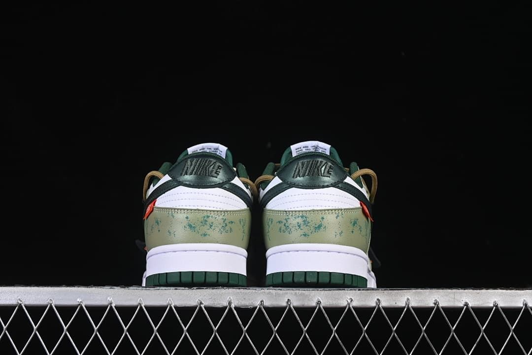 Rear view of both shoes showing green patterned heel panels
