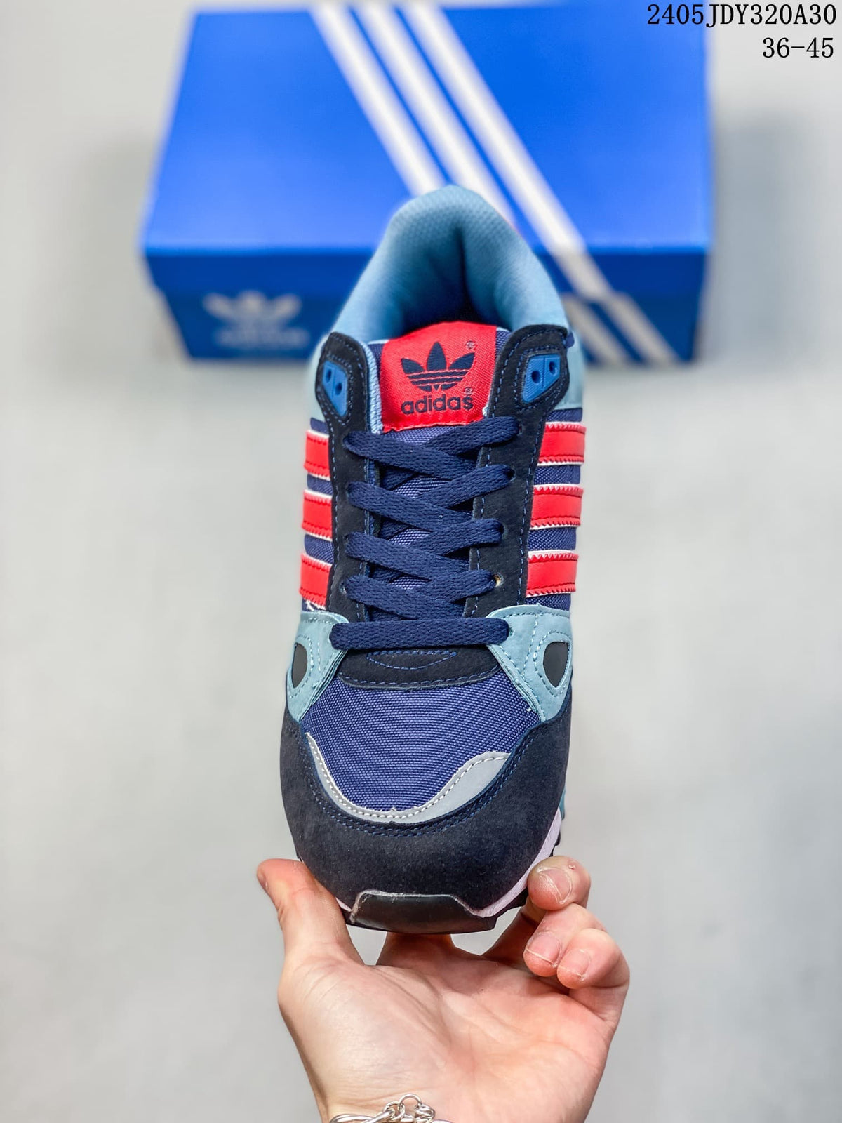 Front view of an Adidas Originals ZX 750 sneaker with navy laces and red side stripes.