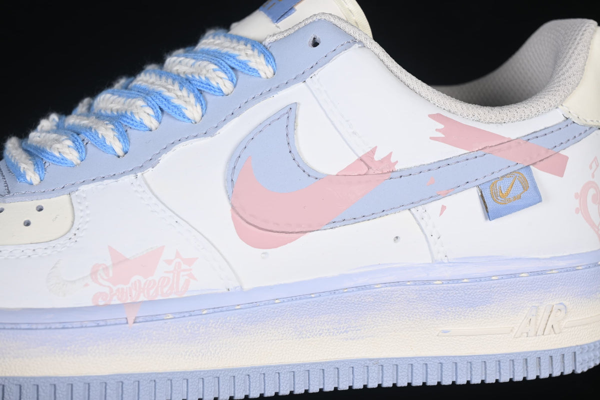 Side detail of the pink graphic overlay, pale blue Swoosh, and Air midsole marking