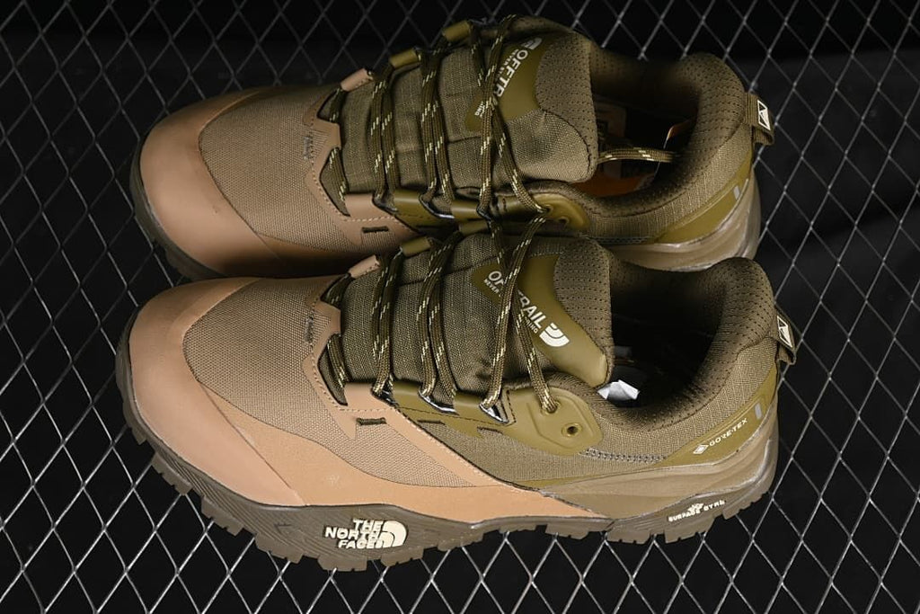 Pair of olive-green and tan hiking shoes viewed from above
