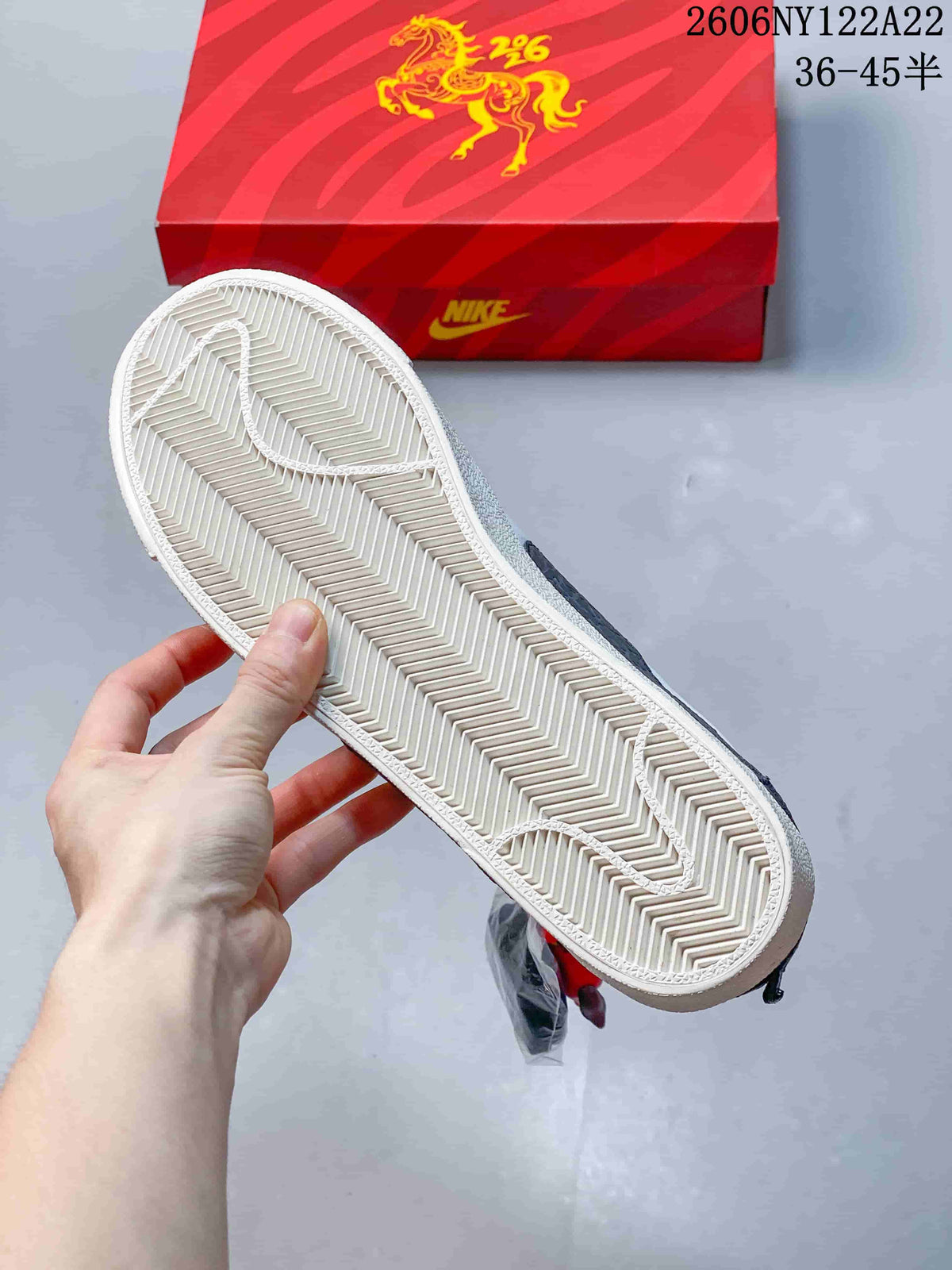 Underside of the sneaker showing a textured herringbone-style outsole.