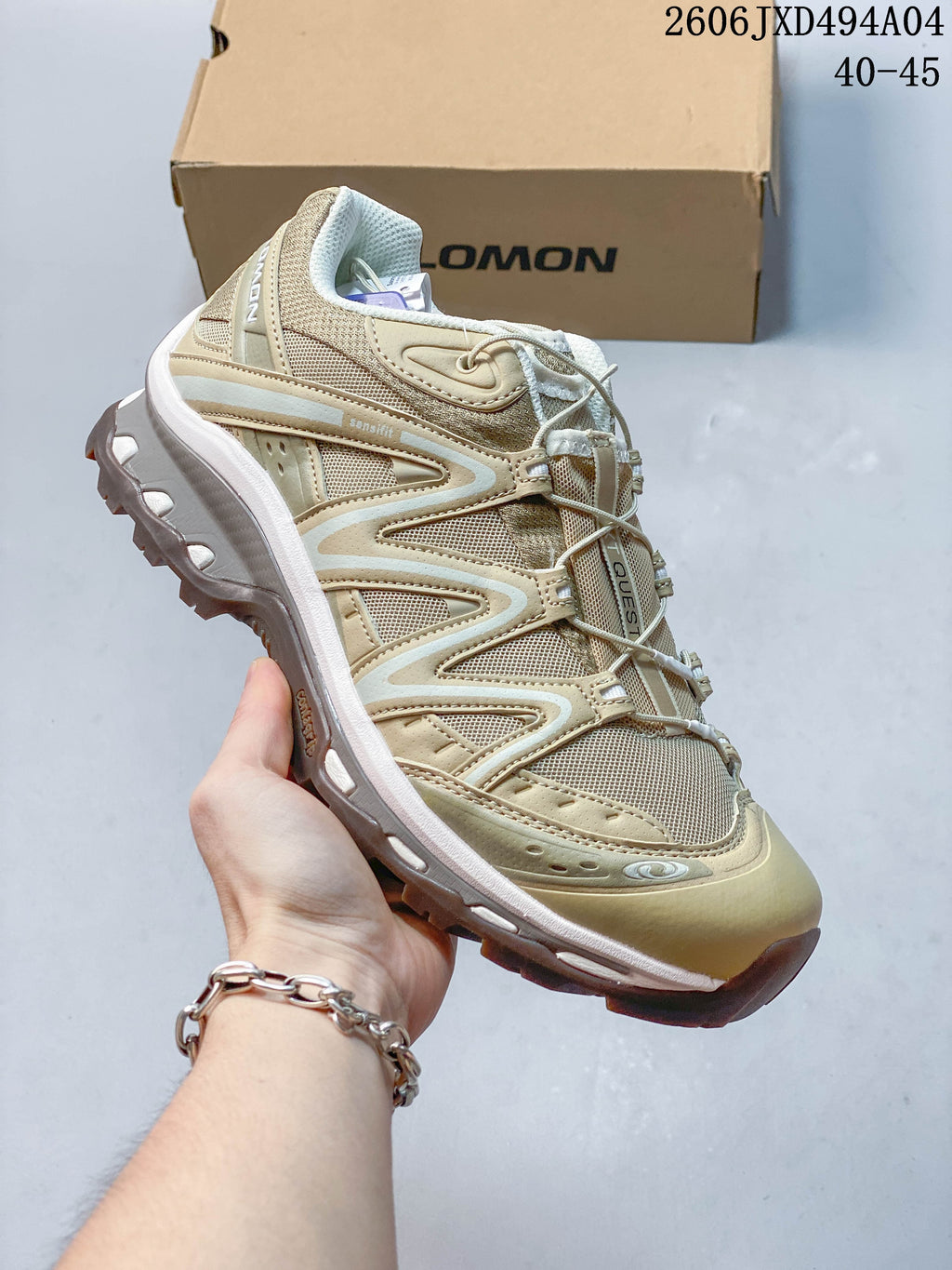 Side view of a sand and gray Salomon XA Pro 3D sneaker showing its overlays and outsole.
