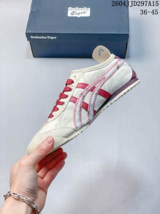 Side profile of the white and red sneaker highlighting the layered upper and low-top silhouette.