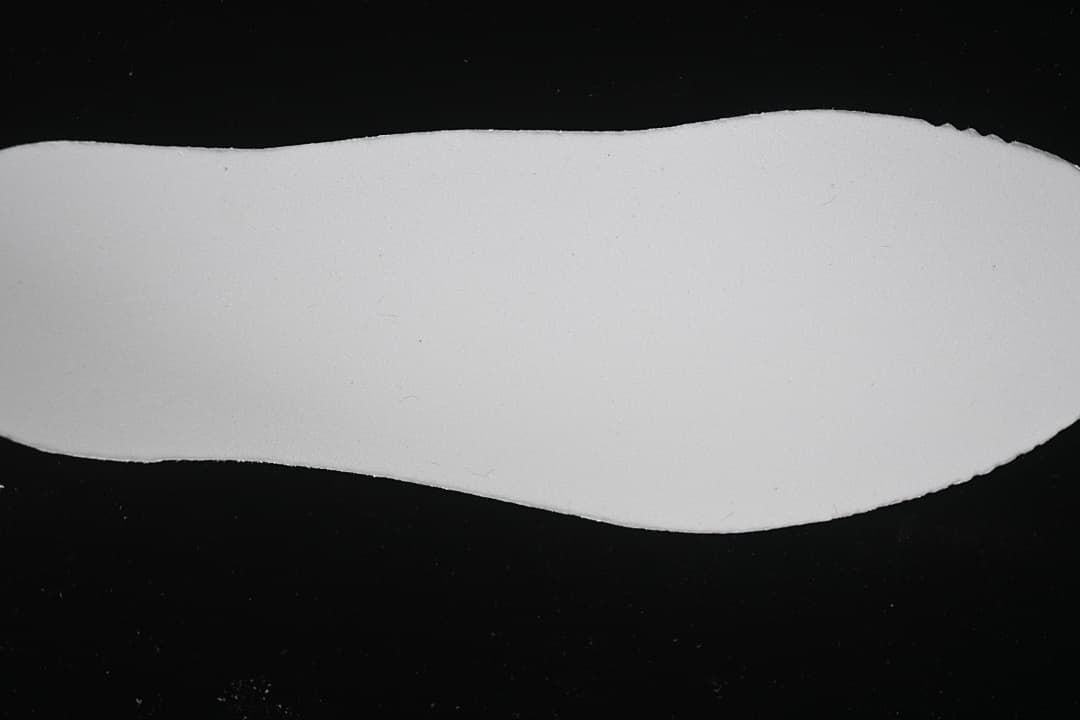White sneaker outsole shown against a dark background