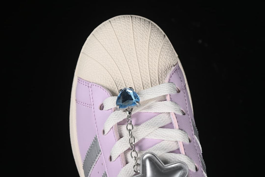 Top view of shell toe, laces, and blue and silver lace charms