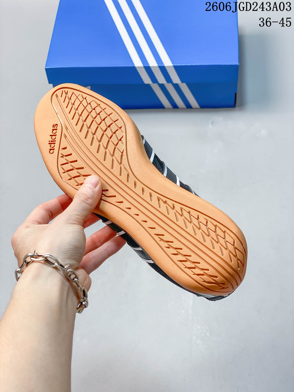 Underside of a sneaker showing the gum-colored outsole and tread pattern