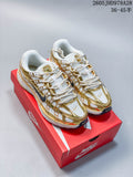 Pair of white and gold-tone Nike Initiator shoes on a red shoebox