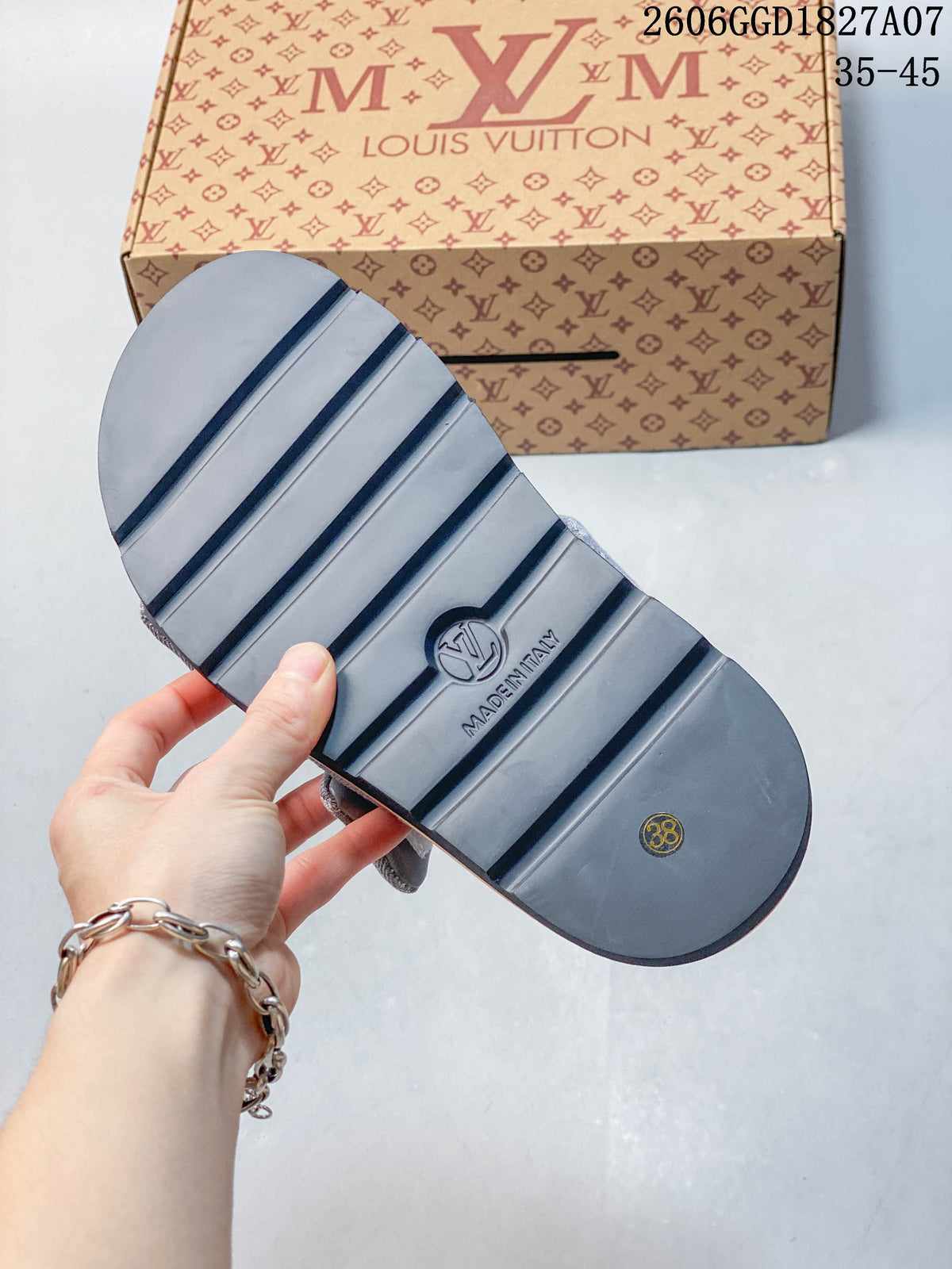 Underside of a gray slide sandal with a ridged outsole and a visible size marking of 38.
