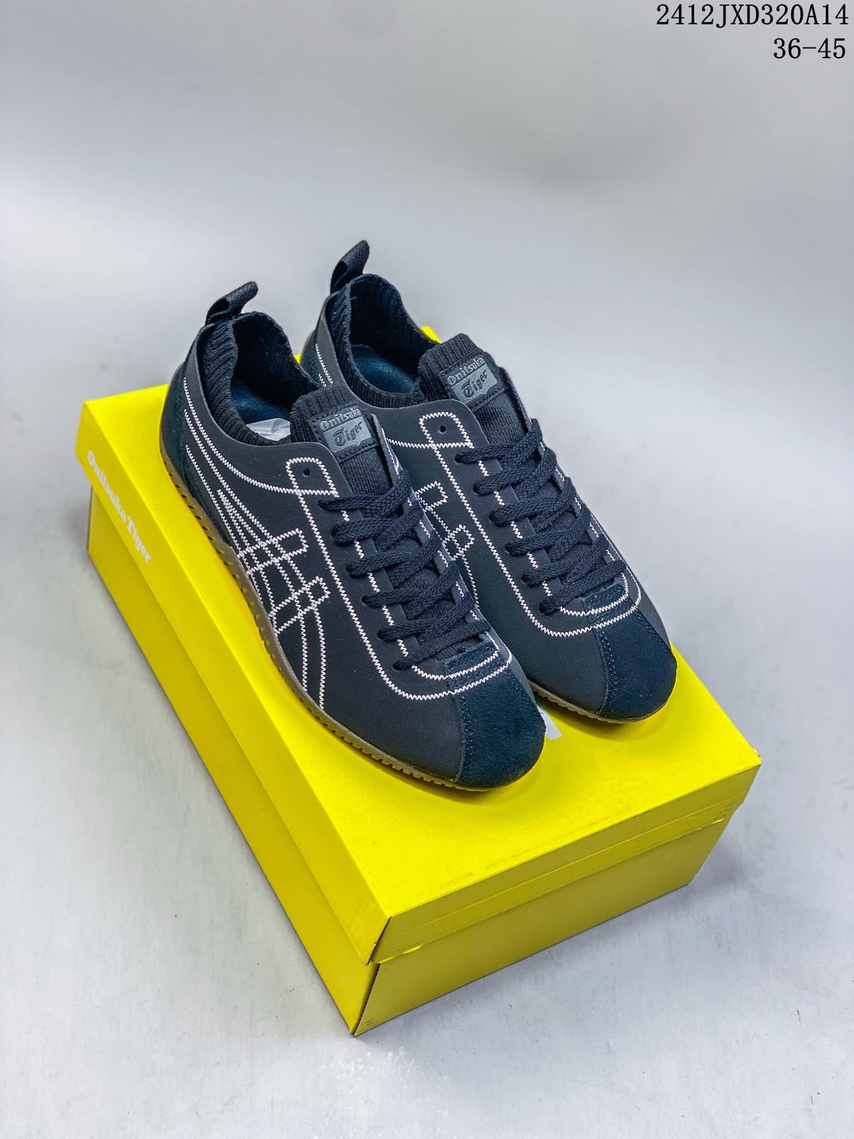 Pair of navy Onitsuka Tiger SCLAW low-top sneakers on a yellow box, showing white side stitching and ribbed collars.