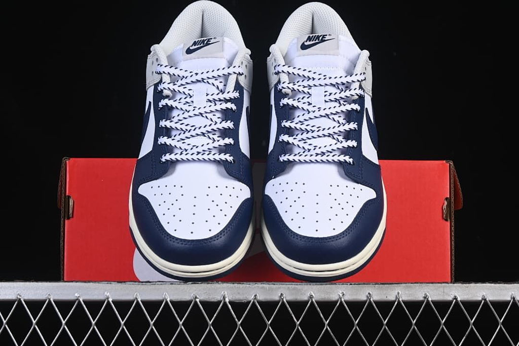 Front view of both sneakers showing perforated toes and contrast laces