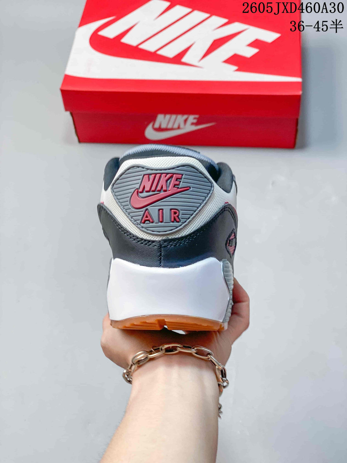 Rear view of the Nike Air Max 90 showing heel branding and the gum-colored outsole.