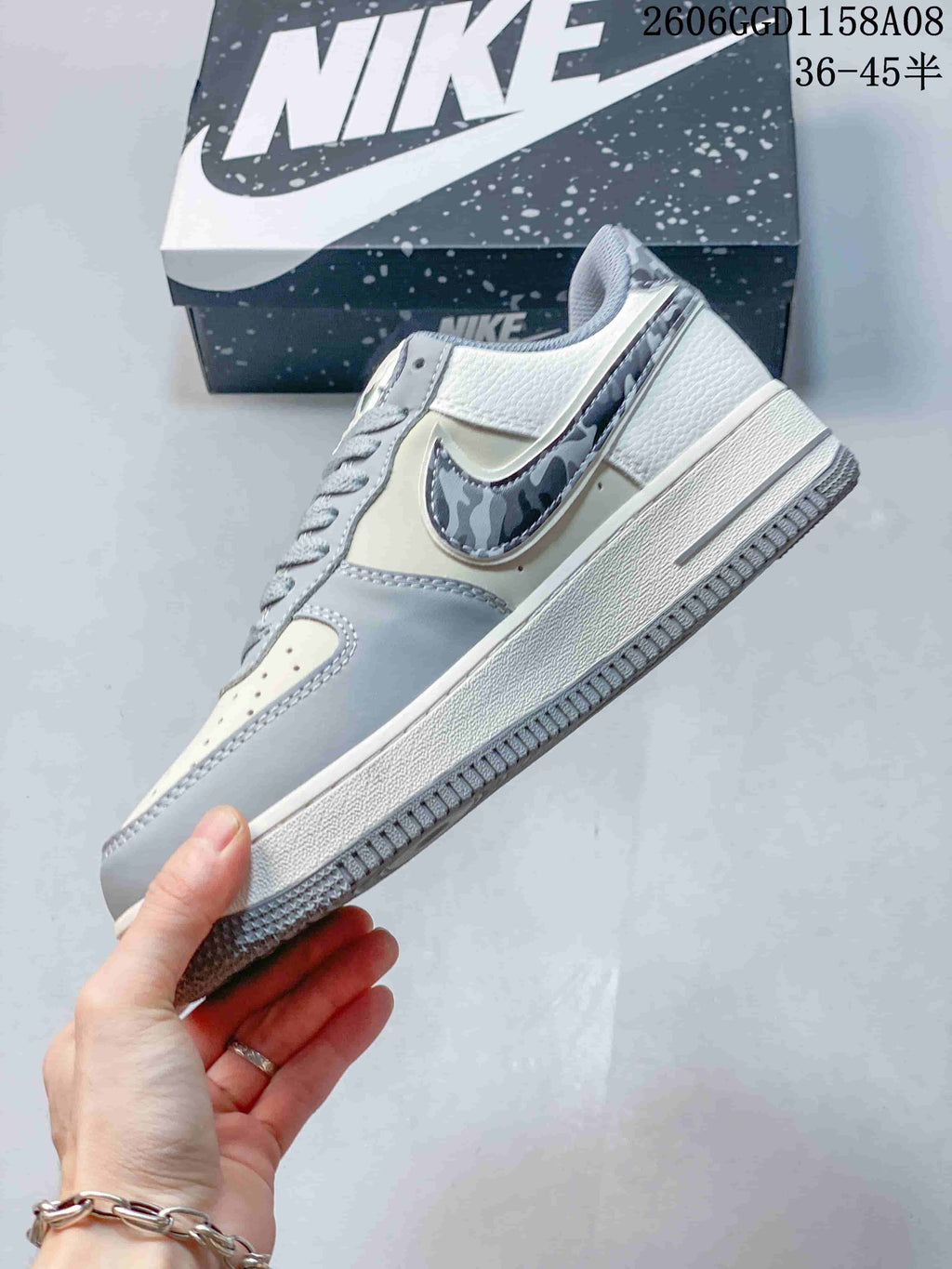 Side view of the cream and gray sneaker with a patterned side accent