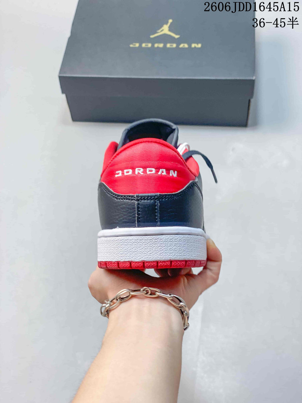 Rear view of a Jordan Court Connect sneaker with red heel lining and white midsole