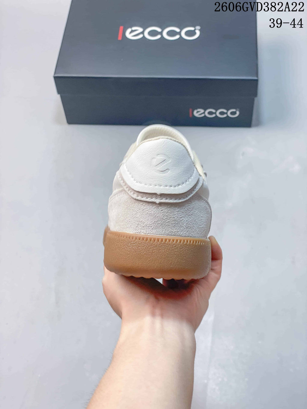 Rear view of a light-colored sneaker with a gum sole
