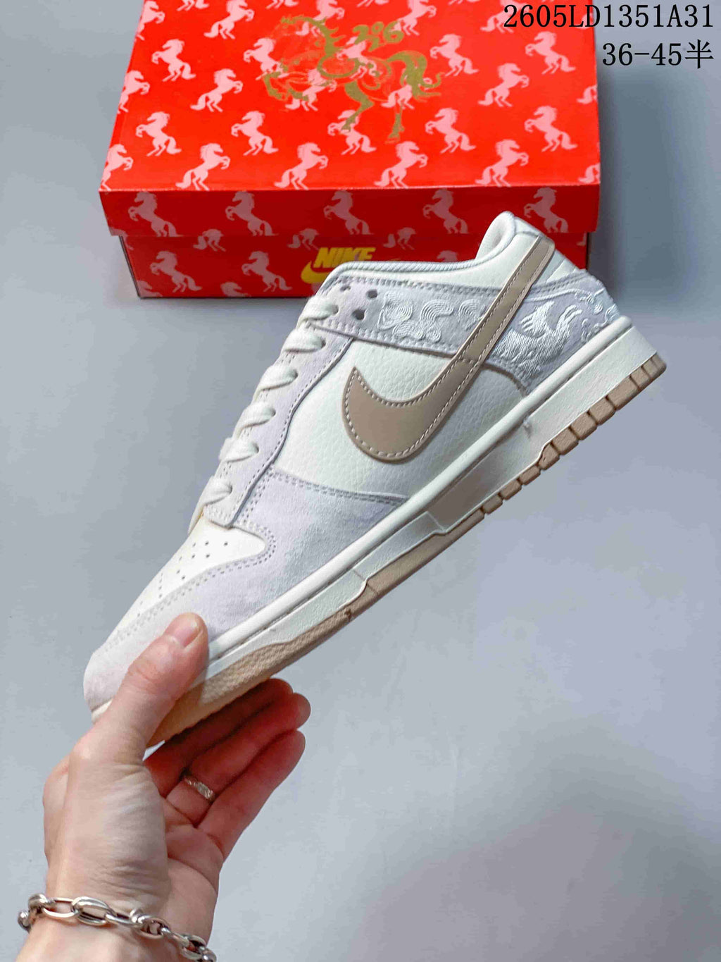Side view of an off-white Dunk Low with a taupe Swoosh and horse-inspired embroidery