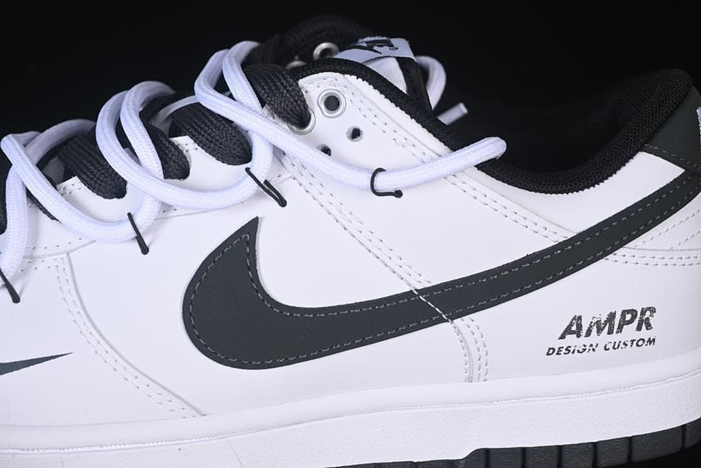Side detail of the black Swoosh, layered laces, and heel graphic