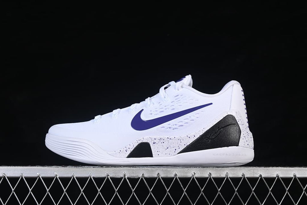 Side view of white Nike Kobe 9 Stitches Low shoes with purple swoosh and black speckled accents