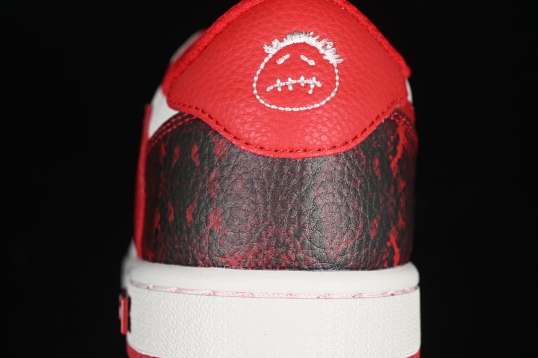 Close-up of the red heel tab and dark patterned heel panel.